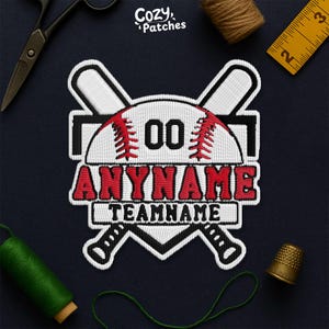 May include: Embroidered baseball patch featuring a white and red baseball design. The patch includes the text "ANYNAME" and "TEAMNAME" in red, with the number "00" in the centre. The patch is surrounded by crossed baseball bats.