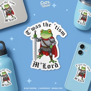 May include: A sticker featuring a cartoon frog in armour holding a sword, with the text "T'was the 'tism M'Lord." The sticker is white with black text and a blue background. Other stickers and items with the same design are also visible.