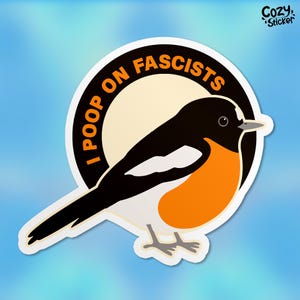 May include: A sticker featuring a cartoon bird with black, white, and orange plumage. The bird is set against a cream-colored circle with the text "I POOP ON FASCISTS" in orange letters. The sticker has a white border and a blue background.