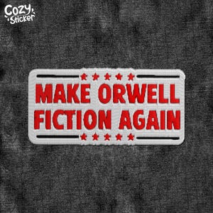 May include: White patch with red embroidered text that reads "MAKE ORWELL FICTION AGAIN" with a row of red stars above and below the text.