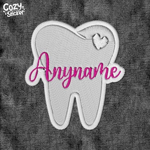 May include: White embroidered tooth with a pink heart and the name "Anyname" in pink lettering on a dark blue denim background.