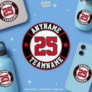 May include: A circular sticker design with the text "ANYNAME" and "TEAMNAME" around a red number "25" on a white background, with a black border and red stars. The sticker is shown on a laptop, phone, and water bottles. The background is light blue.