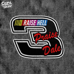 Peut inclure: Patch brodé noir et blanc avec le chiffre 3 au centre. Le texte "Raise Hell" est au-dessus du chiffre, et "Praise Dale" est en dessous du chiffre. Le patch est sur un fond en jean.