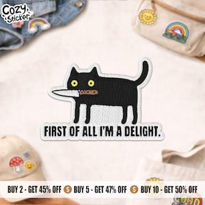 May include: Embroidered black cat patch with yellow eyes, holding a knife and a small brown object. The text "FIRST OF ALL I'M A DELIGHT" is below the cat. The patch is surrounded by other patches and accessories.