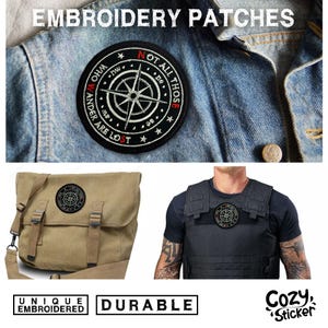 May include: Black embroidered patch with a compass design and the text "NOT ALL THOSE WHO WANDER ARE LOST." The patch is shown on a denim jacket, a canvas bag, and a vest. The image also includes the words "UNIQUE EMBROIDERED" and "DURABLE."