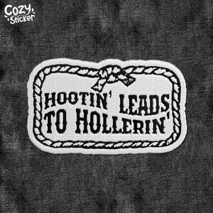 May include: A black and white patch with the text "HOOTIN' LEADS TO HOLLERIN'" in a bold, vintage font. The patch has a rope-like border and a knot design at the top. The patch is on a dark gray denim background.