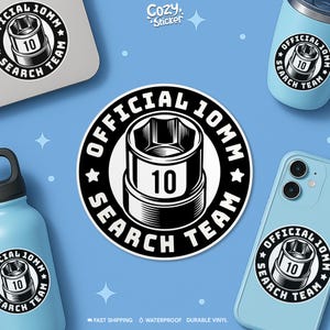May include: A black and white sticker featuring the text "OFFICIAL 10MM SEARCH TEAM" around a socket wrench graphic. The sticker is shown on a laptop, a tumbler, a phone, and a water bottle. The background is light blue.