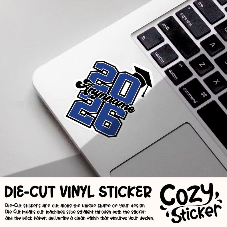 May include: A die-cut vinyl sticker with the text "2026" in blue with a white outline, a graduation cap, and a personalized name. The sticker is on a laptop.