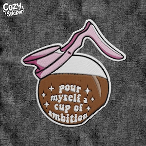 May include: Embroidered iron-on patch with a brown coffee pot and the text "pour myself a cup of ambition".
