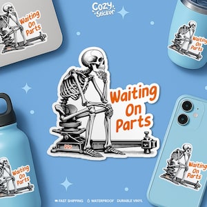 May include: A black and white sticker featuring a skeleton sitting on a mechanical device, with the text "Waiting On Parts" in orange. The sticker is displayed on a laptop, phone, and water bottle.