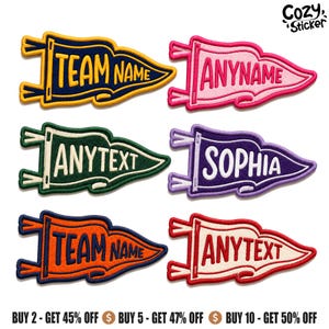 May include: Six pennant-shaped embroidered patches in various colours including navy blue, pink, dark green, purple, orange, and cream. Each patch features custom text such as TEAM NAME, ANYNAME, ANYTEXT, and SOPHIA with stitched borders.