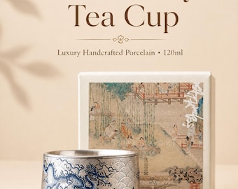 May include: A silver-toned tea cup featuring a blue dragon and wave pattern, accompanied by a square white box with a printed historical scene. The text on the image reads Gift-Ready Tea Cup, Luxury Handcrafted Porcelain, and 120ml.
