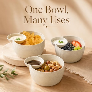 May include: Three off-white speckled ceramic bowls with integrated side compartments for dipping sauces. The text "One Bowl, Many Uses" is displayed above. The bowls contain tortilla chips, fresh fruit with yogurt, and mixed nuts with sauce.