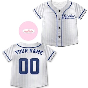 May include: White baseball jersey with blue stripes and navy blue trim. The back of the jersey has "YOUR NAME" and the number "00" in navy blue.