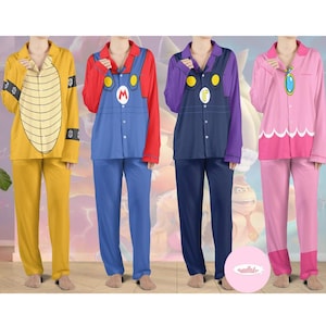 May include: Four sets of character-themed pajamas. The pajamas include a yellow turtle shell design, a blue Mario design, a purple Luigi design, and a pink Princess Peach design. Each set includes a button-down top and matching pants.