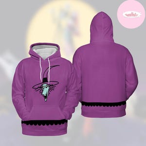May include: Purple hooded sweatshirt featuring a cartoon character with a witch hat. The front of the sweatshirt displays the character's face, while the back is solid purple. A black scalloped trim accents the bottom.