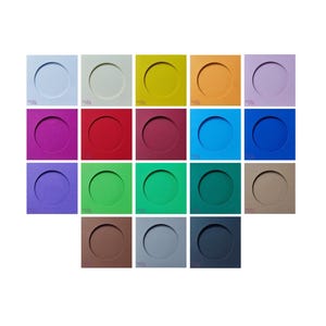 May include: A selection of colourful square coasters in shades of blue, green, red, and yellow. Each coaster has a circular indentation in the centre. The coasters are arranged in a grid pattern against a white background.