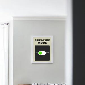 May include: A white framed print with a black background and white text that reads "Creative Mode". A green toggle switch is shown with the word "ON" to the left and "OFF" to the right.