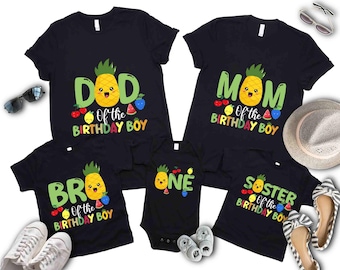 May include: Black family matching birthday shirts with pineapple graphics. The shirts read "Dad", "Mom", "Bro", "One", and "Sister" with the text "Of the Birthday Boy". The shirts have a cartoon pineapple design and fruit accents.