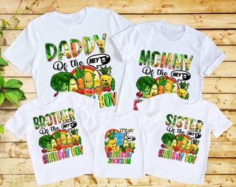 May include: White t-shirts with colorful fruit and vegetable graphics. The shirts read "Daddy," "Mommy," "Brother," "Sister," and "It's My 1st Birthday Jackson." Each shirt features a cartoon design of various fruits and vegetables.