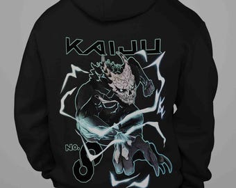 May include: Black hoodie featuring a detailed illustration of a monster with the word "KAIJU" above it. The design includes lightning bolts and the number "6". The monster has a skull-like face and is in a dynamic pose.