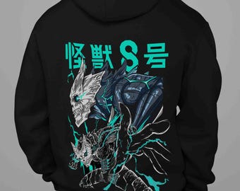 May include: Black hooded sweatshirt featuring a teal graphic of a monster with the Japanese text "Kaiju No. 8". The design includes a detailed illustration of a monster with a skull-like face and teal lightning effects.
