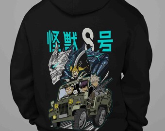 May include: Black hooded sweatshirt featuring a colorful graphic of an anime-style jeep with characters and a monster. The text "怪獣8号" is above the graphic in teal. The jeep is olive green.