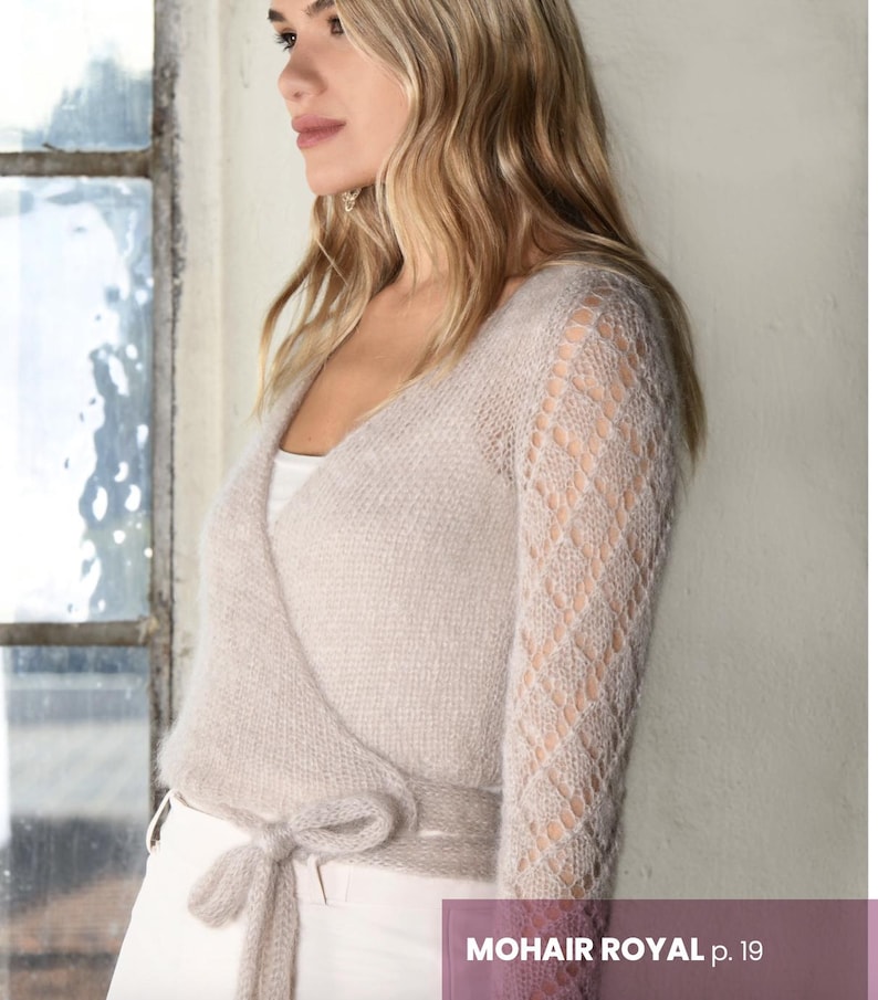 May include: A light beige wrap cardigan with a delicate openwork pattern on the sleeves. The cardigan is tied at the waist with a long sash.
