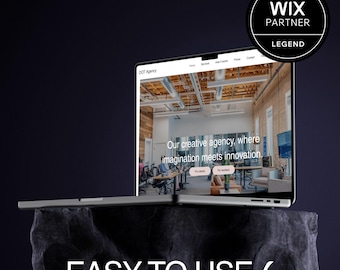 May include: A silver laptop displaying a website with the text "DOT Agency" and the tagline "Our creative agency, where imagination meets innovation." The laptop is on a dark, textured surface with the words "EASY TO USE" below. A Wix Partner Legend badge is in the upper right.