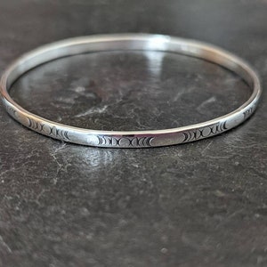 dainty sterling silver bangle with moon phases - handmade and hand stamped