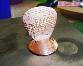 copper guitar pick with music notes with stand - fresh from the bench