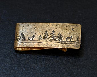 Bronze money clip with howling wolves and a night sky
