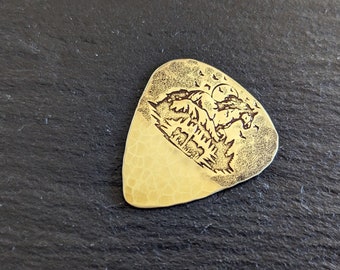 Brass guitar pick with forest and horses - playable brass plectrum