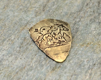 brass shield guitar pick with horse and forest - playable brass guitar pick - NicisPicks