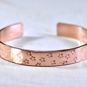 Copper cuff bracelet with hammered texture and stars