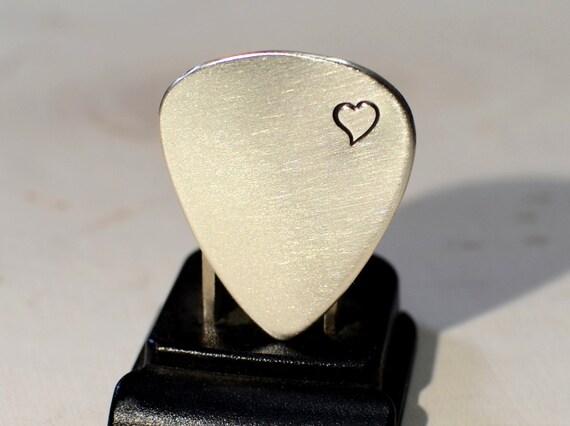 Silver shop guitar pick