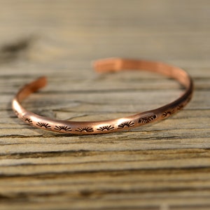 dainty copper cuff bracelet with hand stamped sun pattern and thunderbird - stacking cuff bracelet