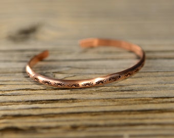 Dainty copper cuff bracelet with hand stamped sun pattern and Thunderbird for stacking