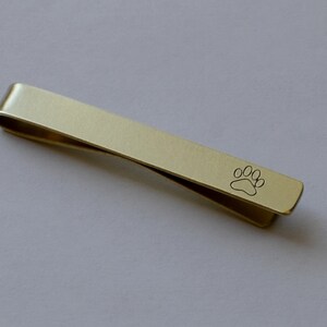 tie bar with a paw print in 14K solid gold