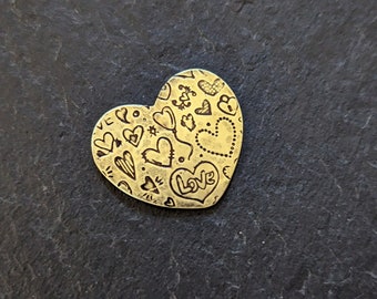 Heart shaped Valentines day guitar pick made from brass