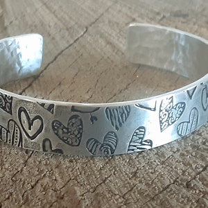 silver cuff bracelet with hearts and hammered texture inside - aluminum - light weight