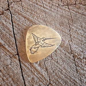 brass guitar pick with hummingbird - playable - hammered texture on the back