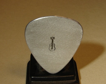 simple silver plectrum with music note