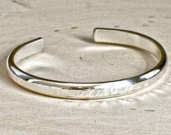 Thick sterling silver cuff bracelet with hammered texture and sparkly finish