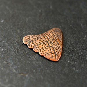 Copper shark tooth guitar pick - playable with non slip backside and a crazy pattern on front