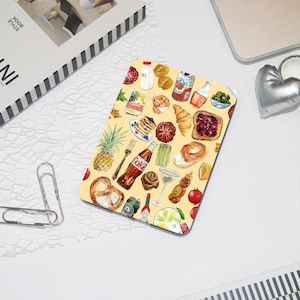 May include: A yellow background with a pattern of various food items, including a pineapple, pretzels, a can of Coke, a croissant, a glass of milk, a jar of jam, a glass of wine, and a lemon slice.