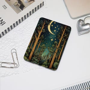 May include: A rectangular case featuring a forest scene with tall trees, a crescent moon, and stars. The color palette includes shades of green, brown, and blue. The case is likely for a tablet or e-reader.