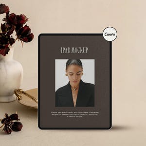 May include: An iPad mockup with a dark brown screen displays a woman wearing gold jewelry. The text "IPAD MOCKUP" is at the top, with additional text below. A vase with dark red flowers is in the background, with the Canva logo in the upper right corner.