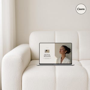 May include: A laptop computer open to a webpage with the text "Olivia Wilson" and a photo of a woman. The laptop is sitting on a white couch.