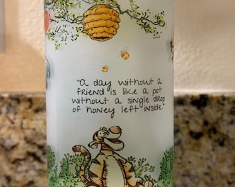 May include: A white frosted glass jar with a bamboo lid featuring a Winnie the Pooh illustration. The jar has a quote from the story: "A day without a friend is like a pot without a single drop of honey left inside."